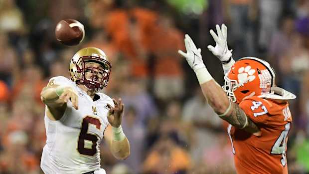 Oct 2, 2021; Clemson, South Carolina, USA; Boston College Eagles quarterback Dennis Grosel (6) throws under pressure form Clemson Tigers linebacker James Skalski (47) at Memorial Stadium. Mandatory Credit: Adam Hagy-USA TODAY Sports